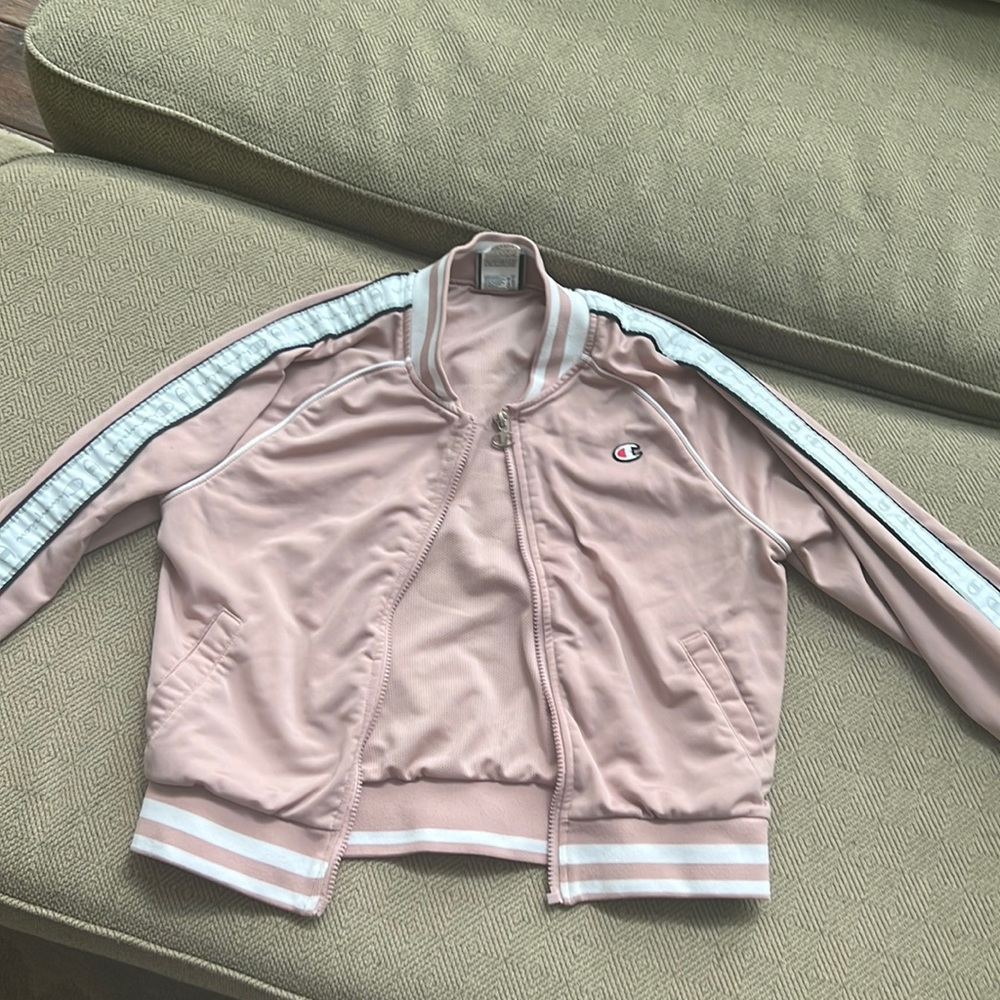 Light pink champion jacket with branding on sleeves